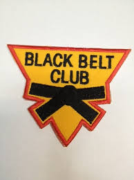 Black Belt Club Badges (triangle shaped) black writing on a gold background